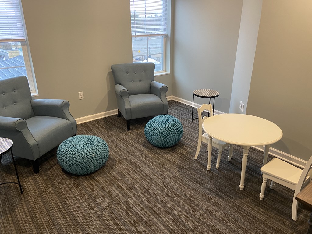 a living room with couches and chairs and a table