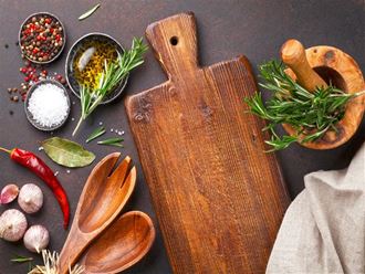 a cutting board with spices and other ingredients on a table