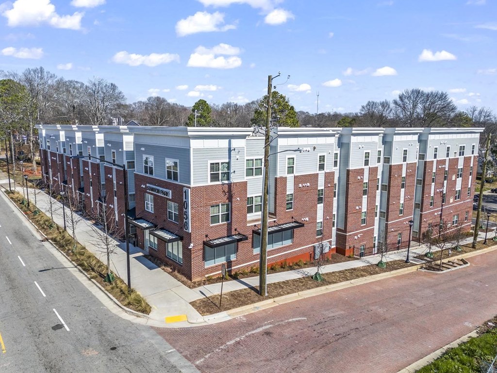 an aerial view of an apartment building on a city street