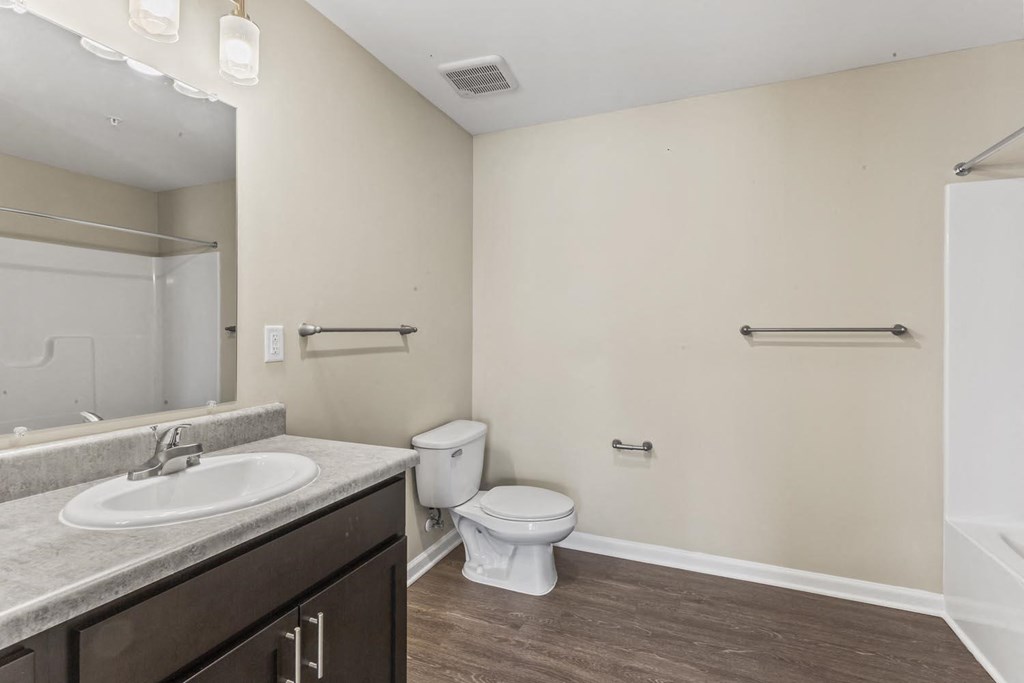 a bathroom with a sink toilet and a mirror