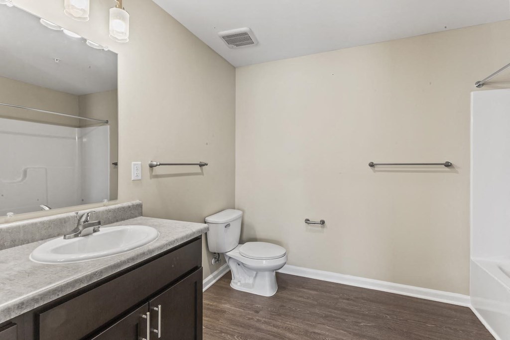 a bathroom with a sink toilet and a mirror