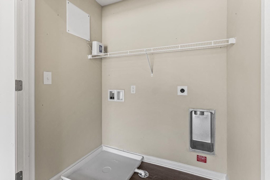 a bathroom with a sink and a toilet and a rack on the wall