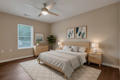 A bedroom with a large bed, a ceiling fan, and two nightstands.