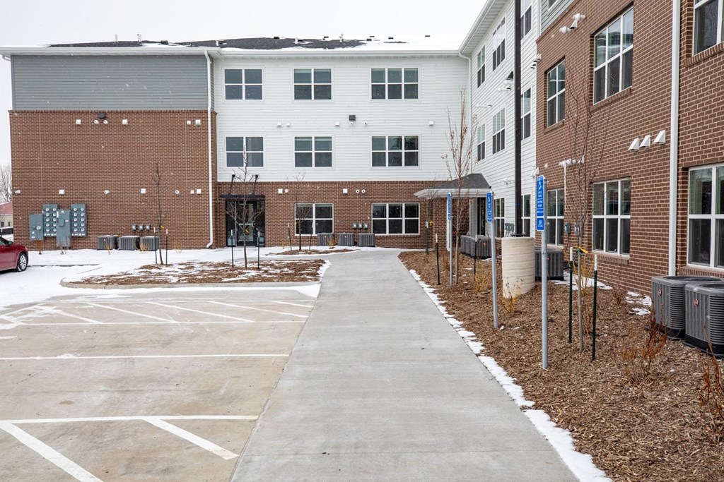 an empty parking lot in front of a brick building