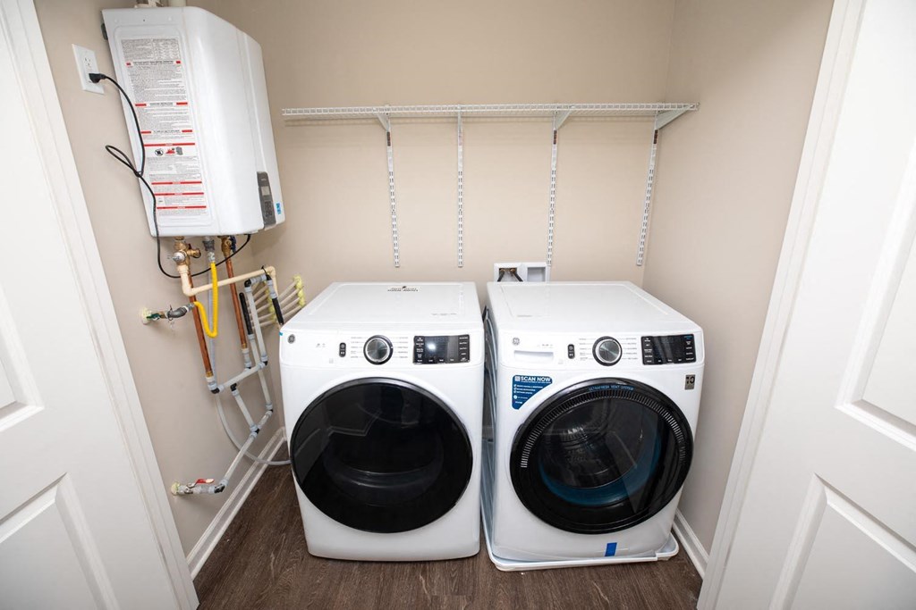 two washing machines in a small laundry room