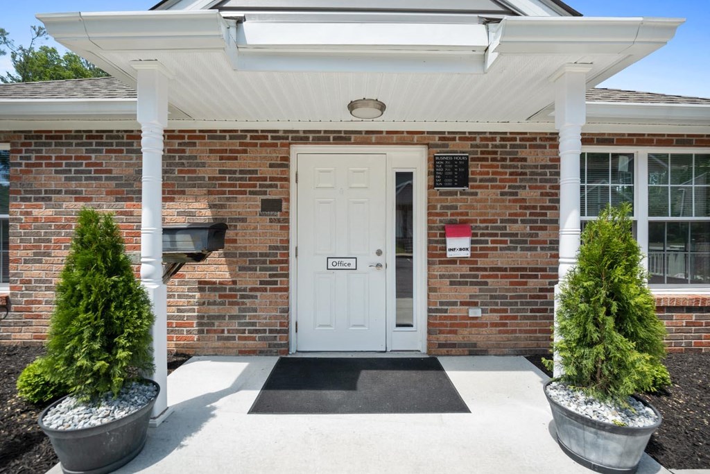the entrance to a brick building with a white door