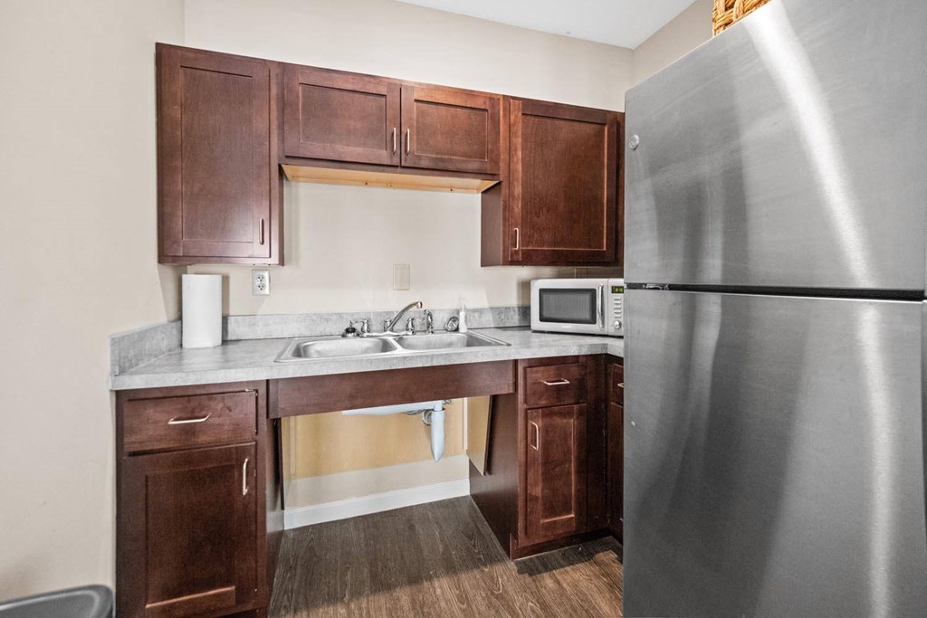 a kitchen with stainless steel appliances and wooden cabinets