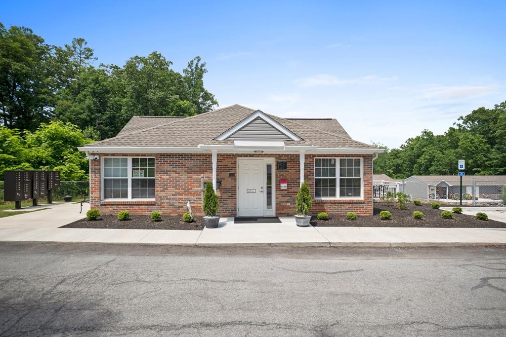 the front of a brick house with a white door
