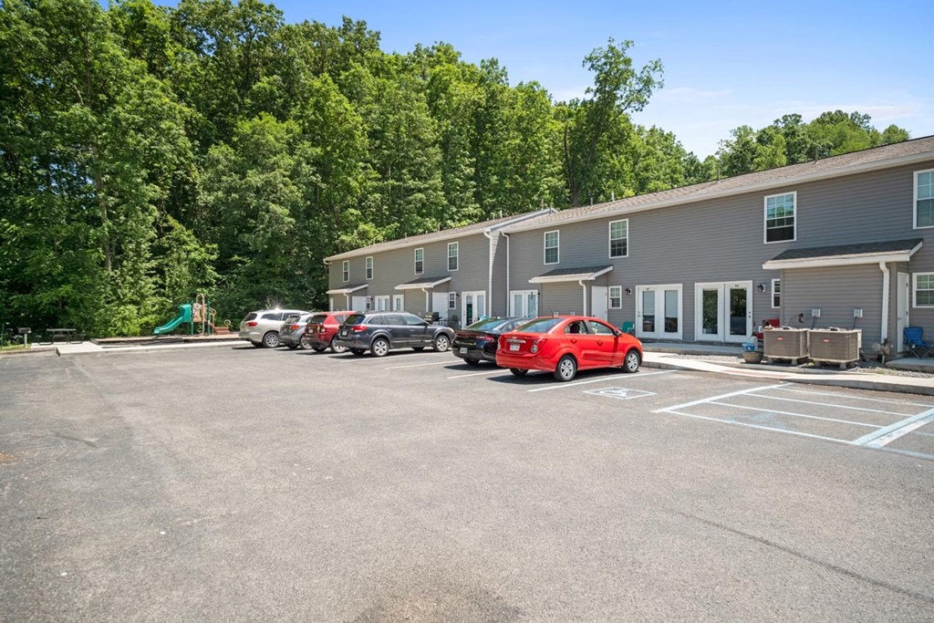 a parking lot with cars in front of a building