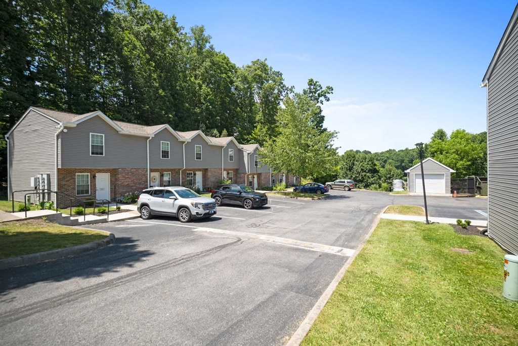 a street with cars parked in front of houses