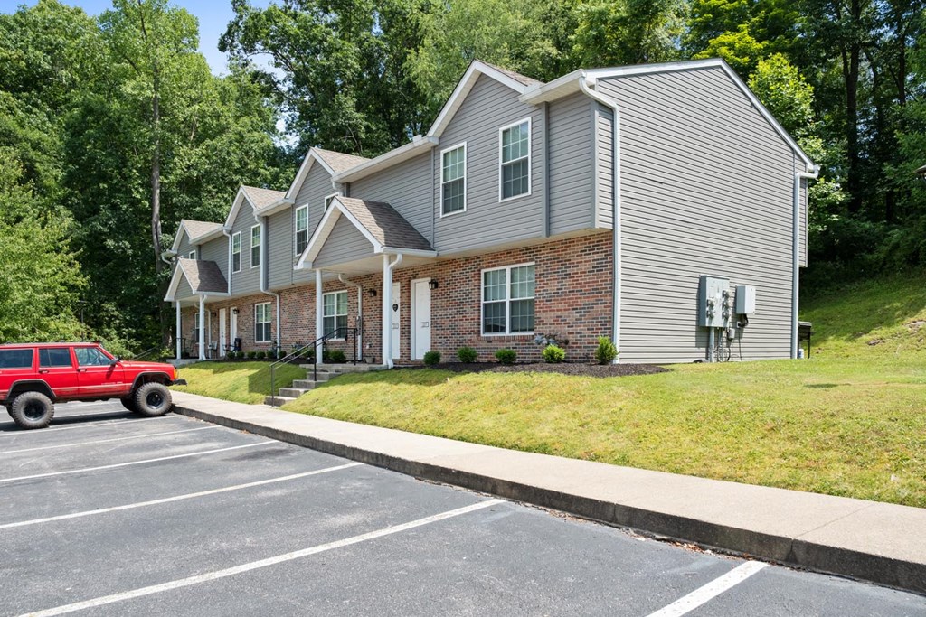 a house with a red truck parked in a parking lot