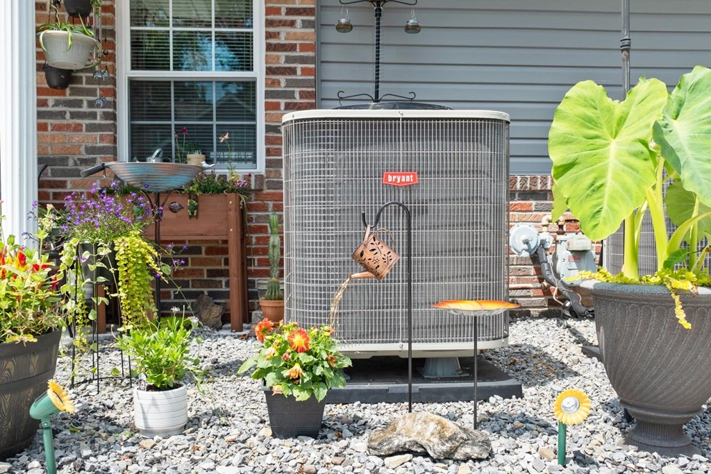 a bird cage in a yard in front of a house