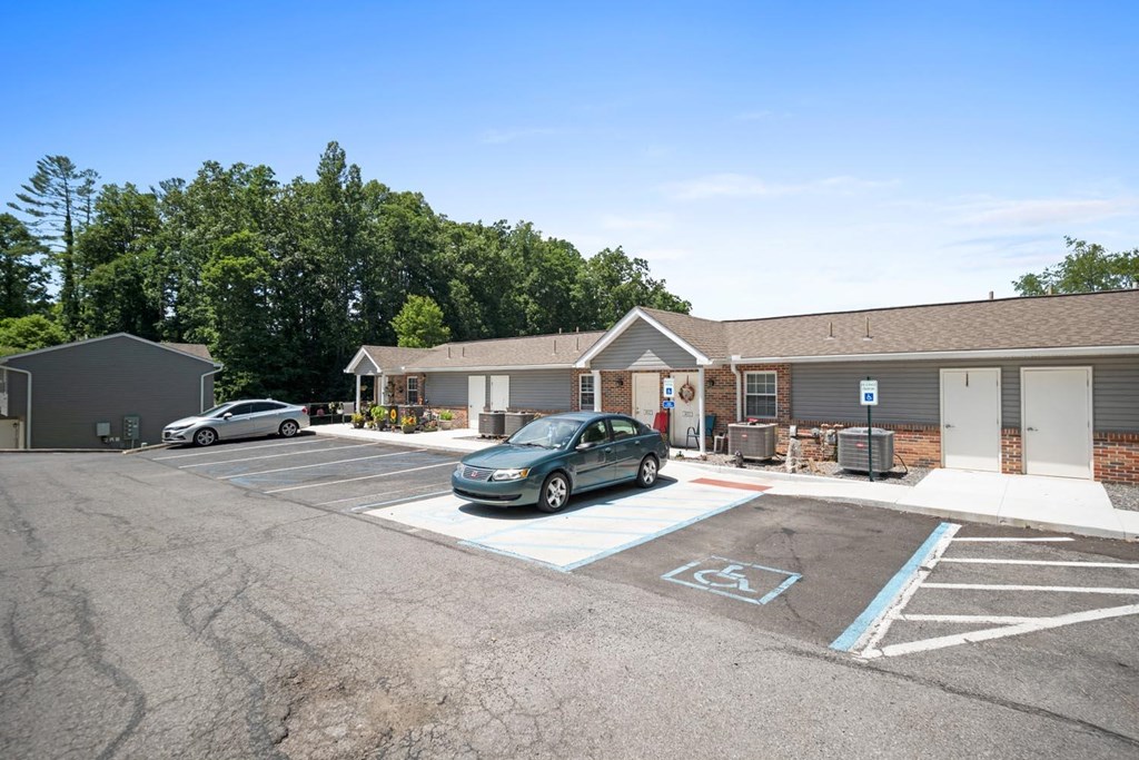 a car parked in a parking lot in front of a building