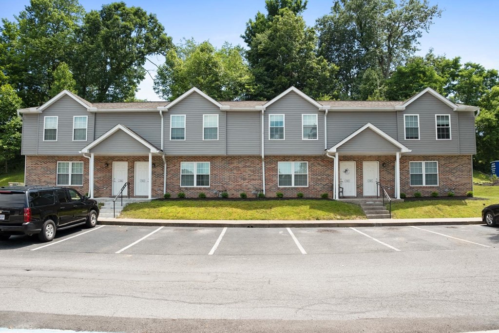 a parking lot in front of an apartment building
