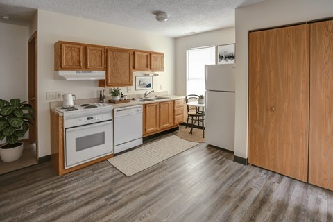 A kitchen with wooden cabinets and a white fridge.