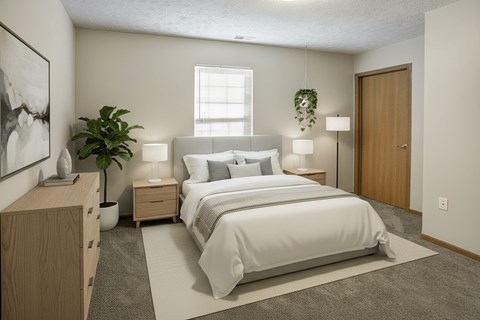 A bedroom with a large bed, nightstands, and a potted plant.