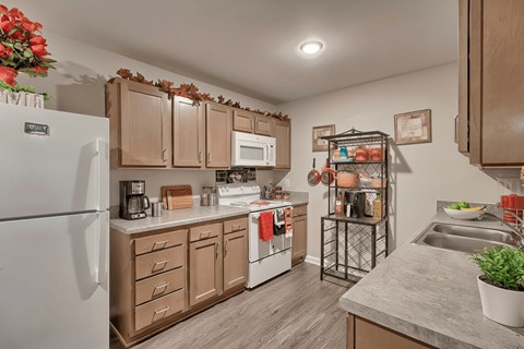 A kitchen with wooden cabinets and a white refrigerator.