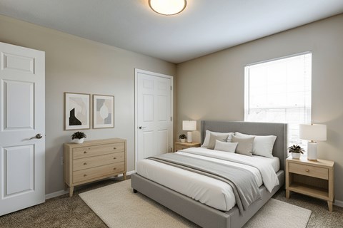A bedroom with a large bed and a dresser.