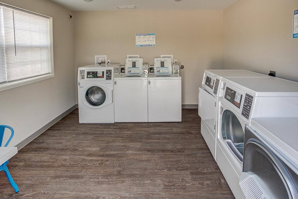 a laundry room with two washes and two washing machines