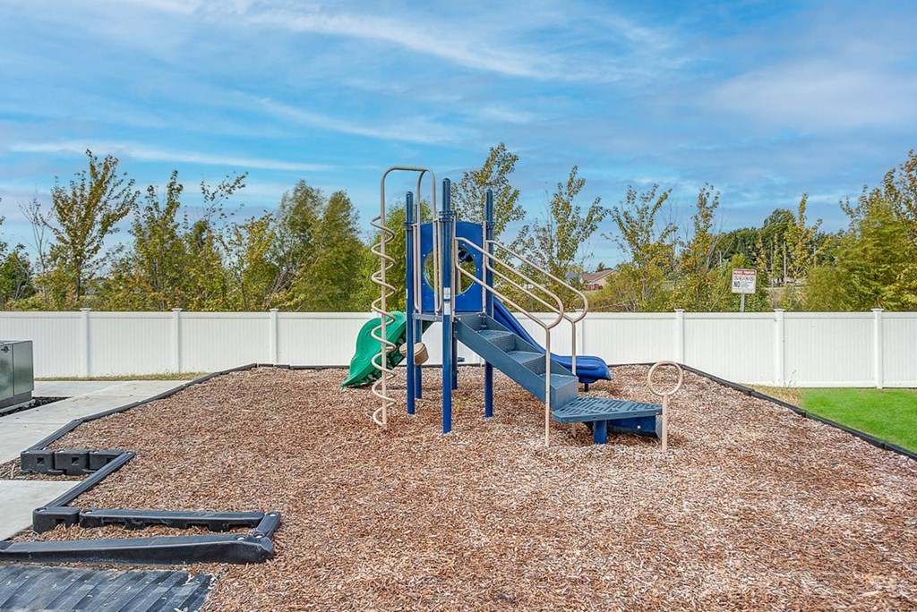 a playground with a blue slide and a green slide