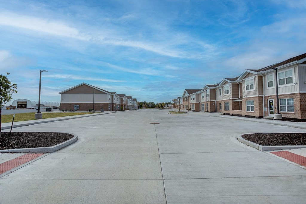 an empty street in front of a row of houses