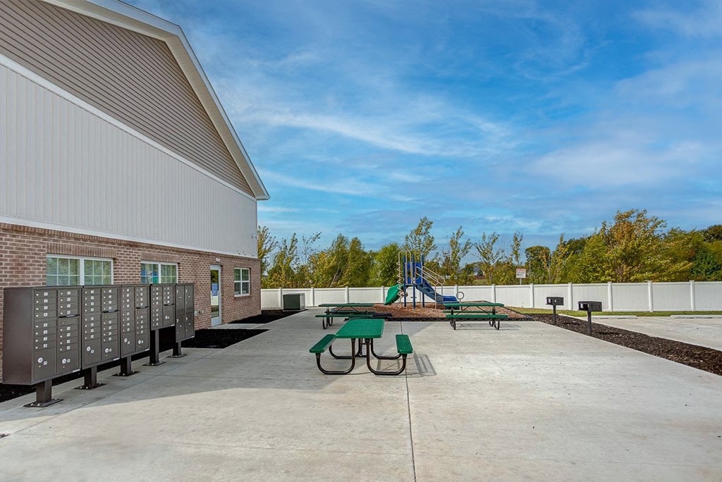 the outlook of our spacious patio with picnic tables and playground equipment