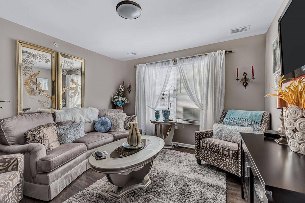 a living room with two couches and two chairs