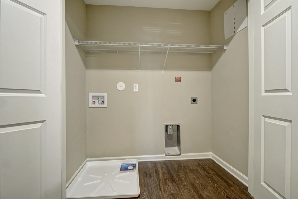 a room with white walls and a white sink and a mirror