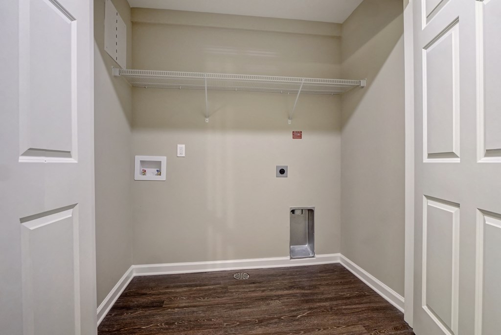 a room with white walls and a wood floor and a white door