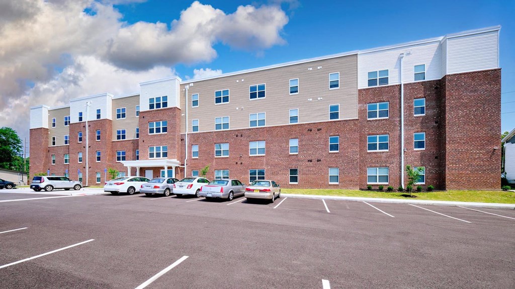 a large brick building with a parking lot in front of it