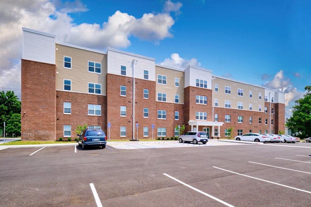a large brick building with a parking lot in front of it