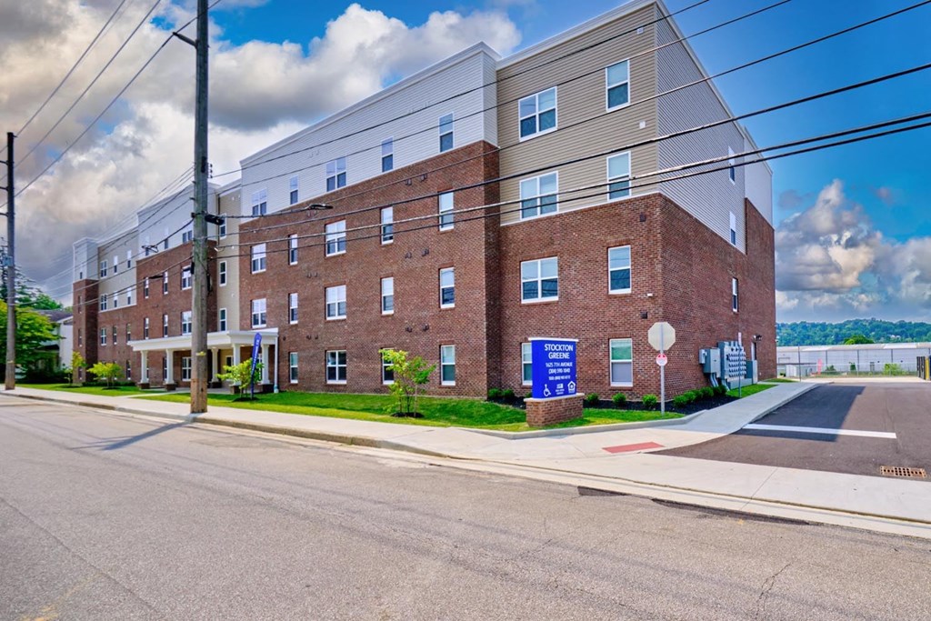a large brick building with a blue sign in front of it