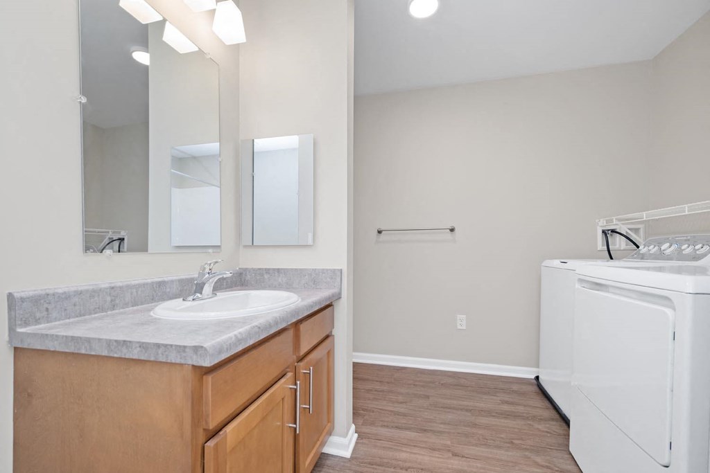 a bathroom with a sink and a washer and dryer