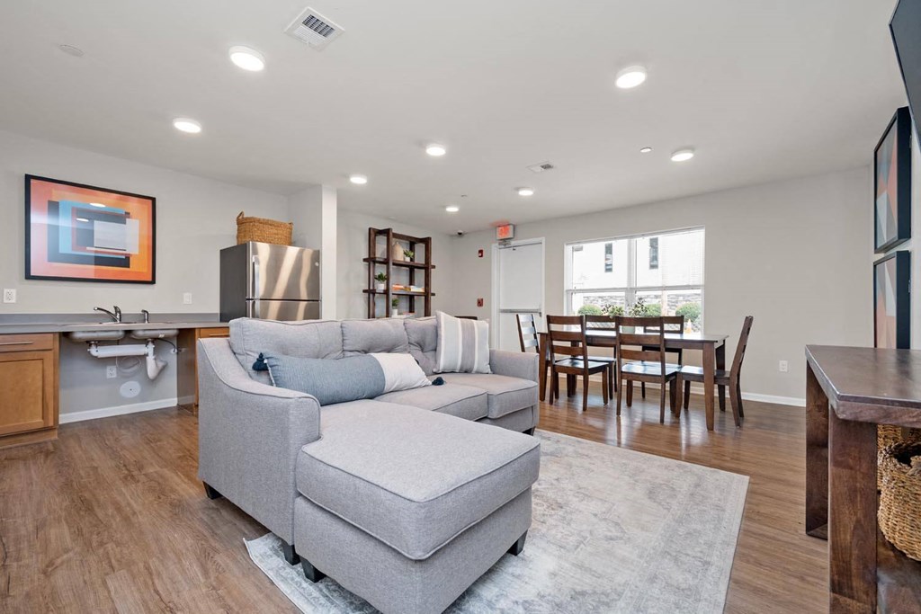 a living room with a couch a table and a sink