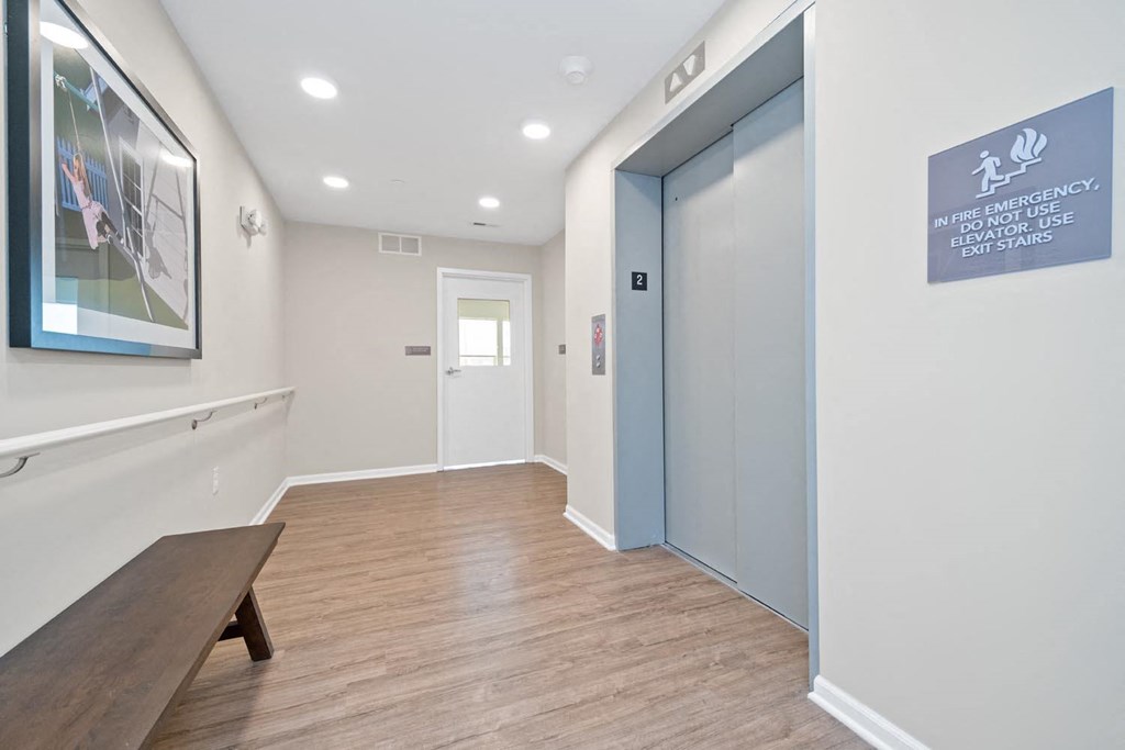 a corridor with a bench and a door