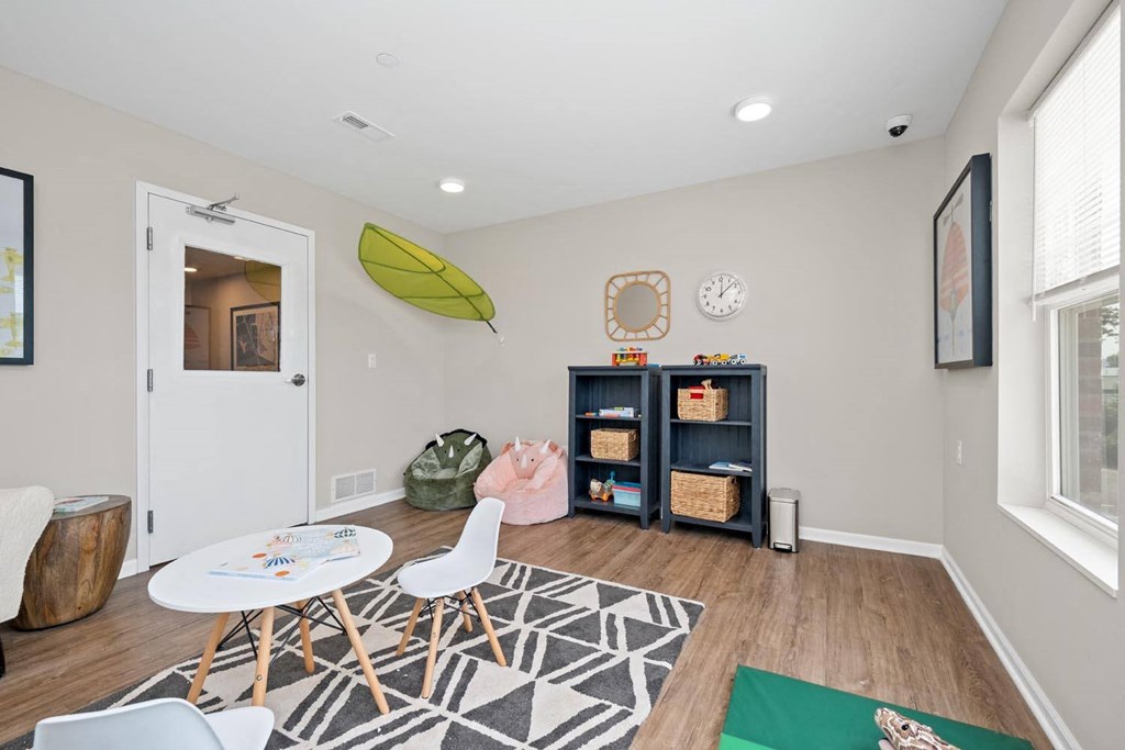 a room with a table and chairs and a bookcase