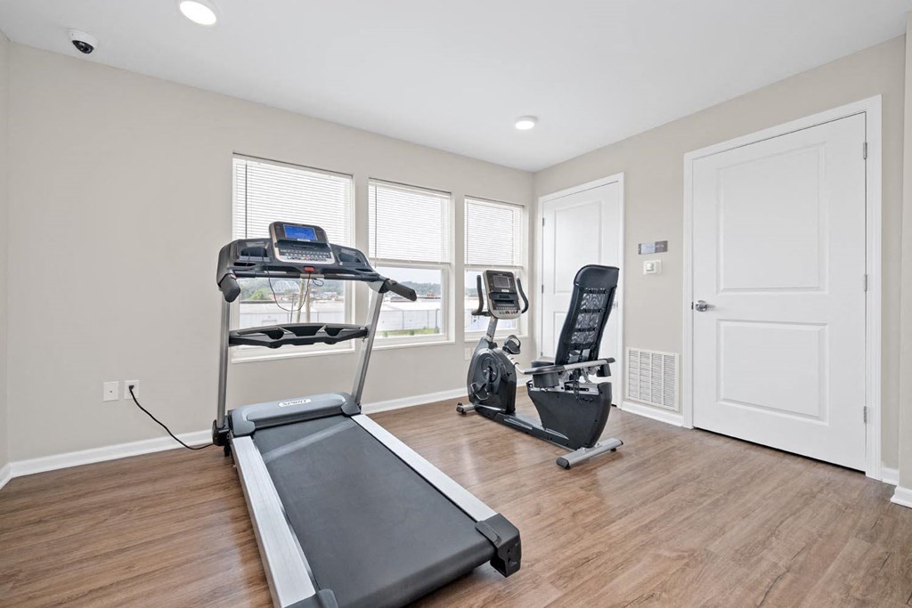 a home gym with a treadmill and exercise balls