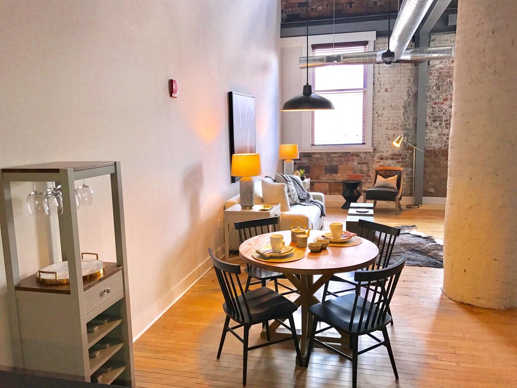 a dining room and living room with a table and chairs