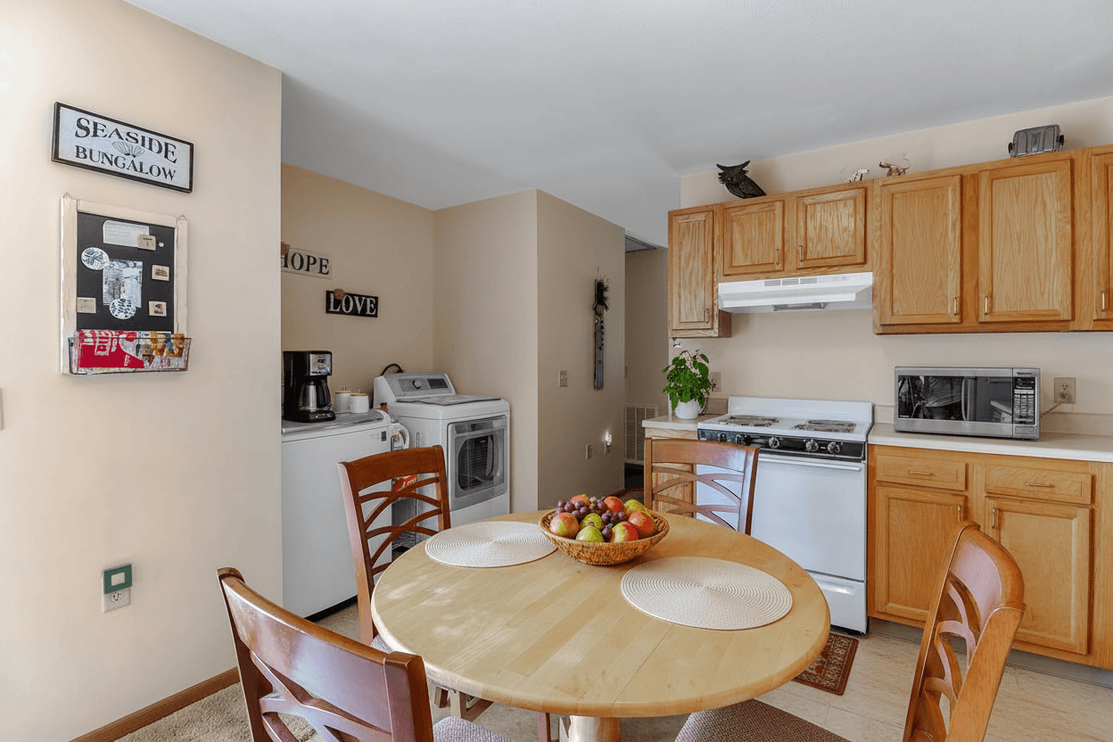 A kitchen with a table and chairs in the middle of the room.