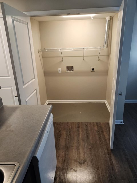 A small laundry room with a washer and dryer.