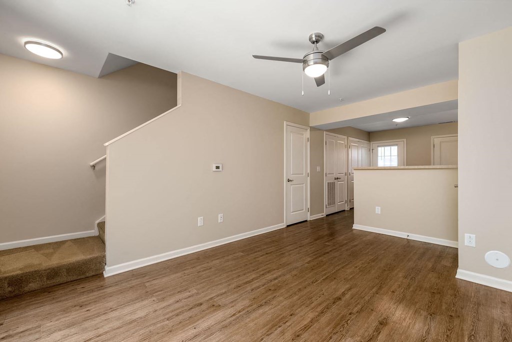 a living room with hardwood floors and a ceiling fan