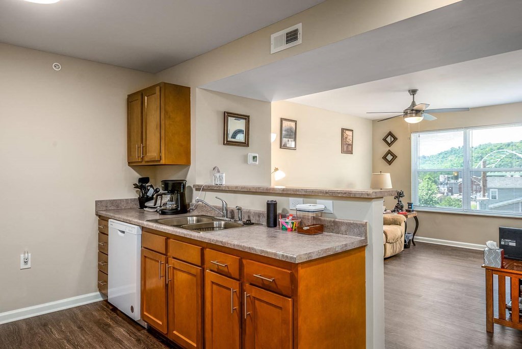 a kitchen with wooden cabinets and a large window
