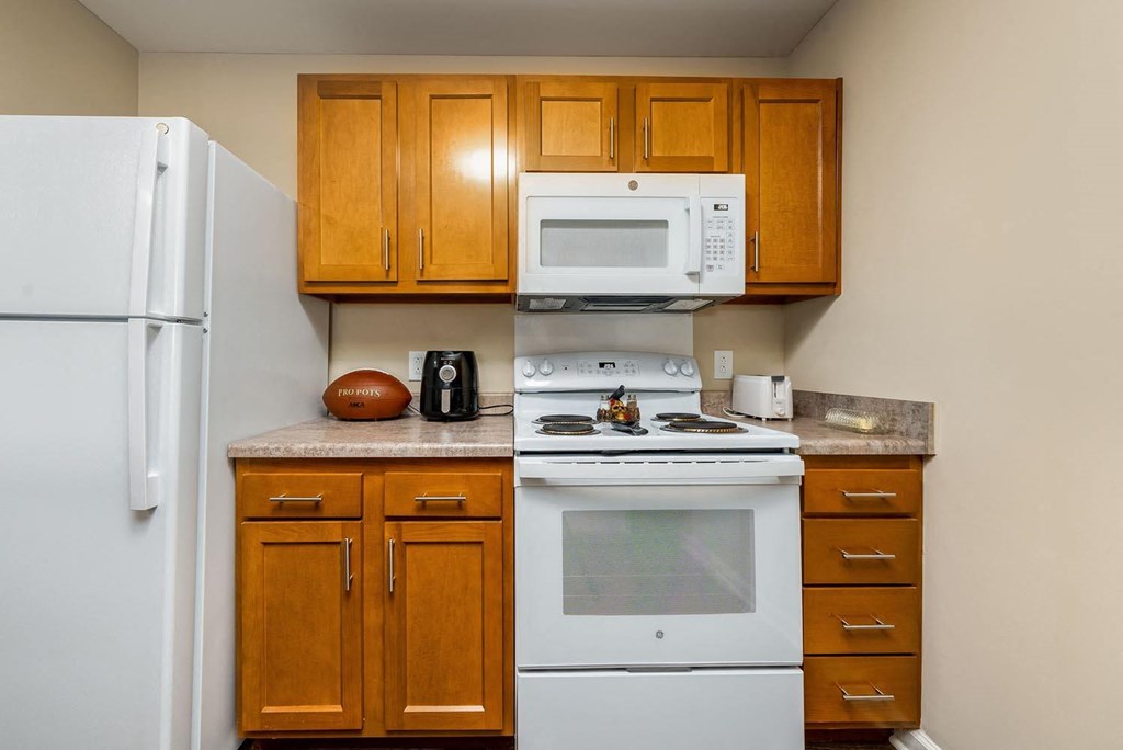 a kitchen with a white stove top oven next to a refrigerator