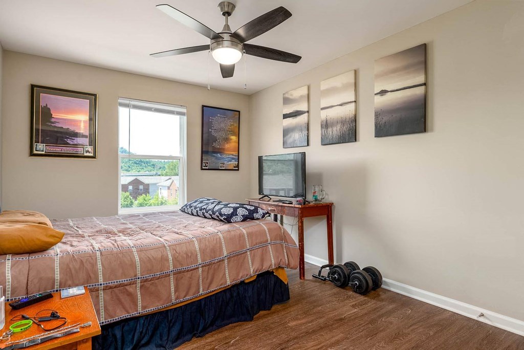 a bedroom with a bed and a tv