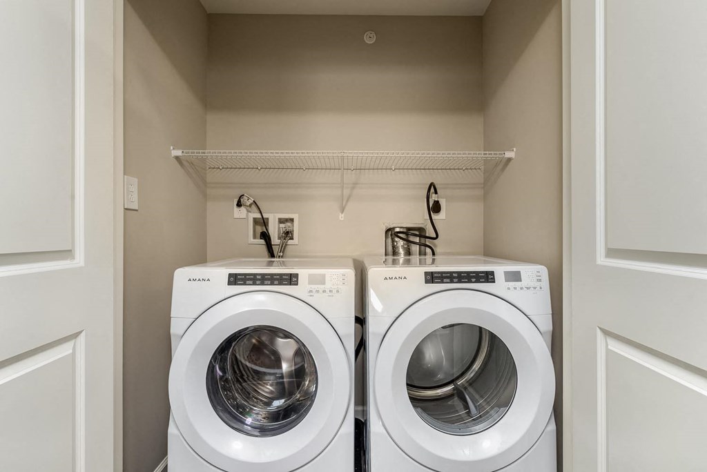 the apartments at lux 96 laundry room with washer and dryer