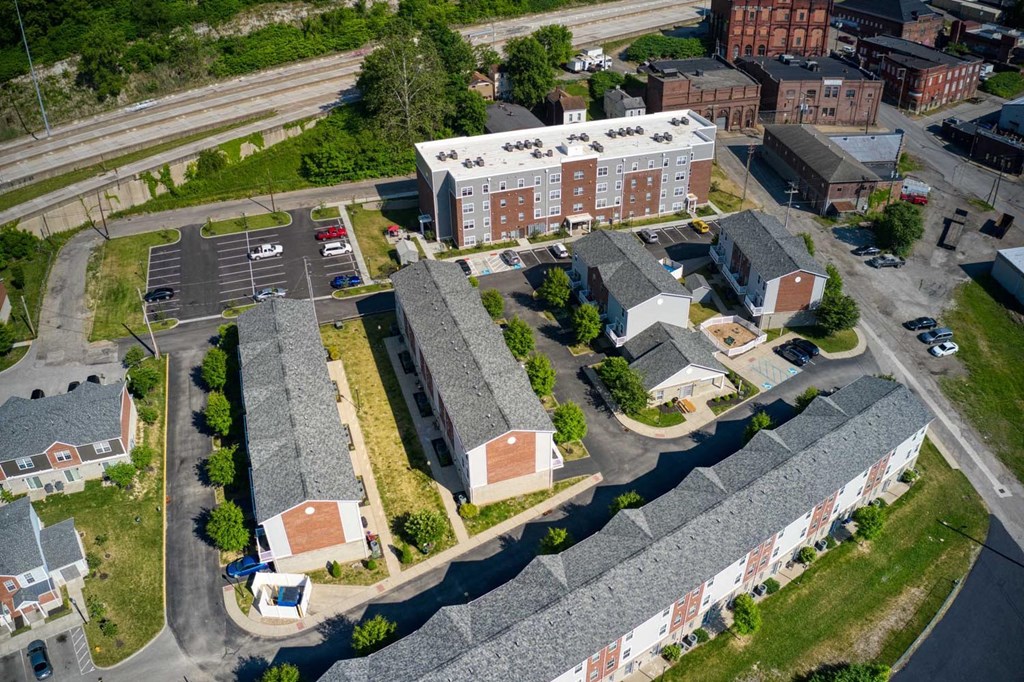 a birdseye view of a neighborhood with brick buildings and cars parked on the side of