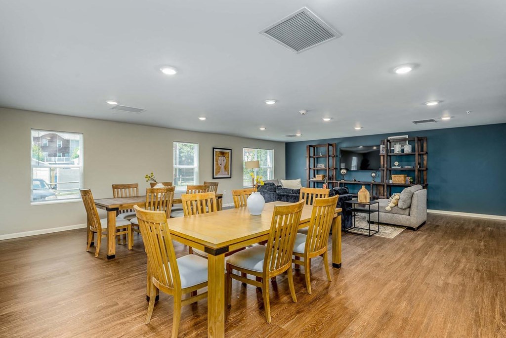 a room with a table and chairs and a couch