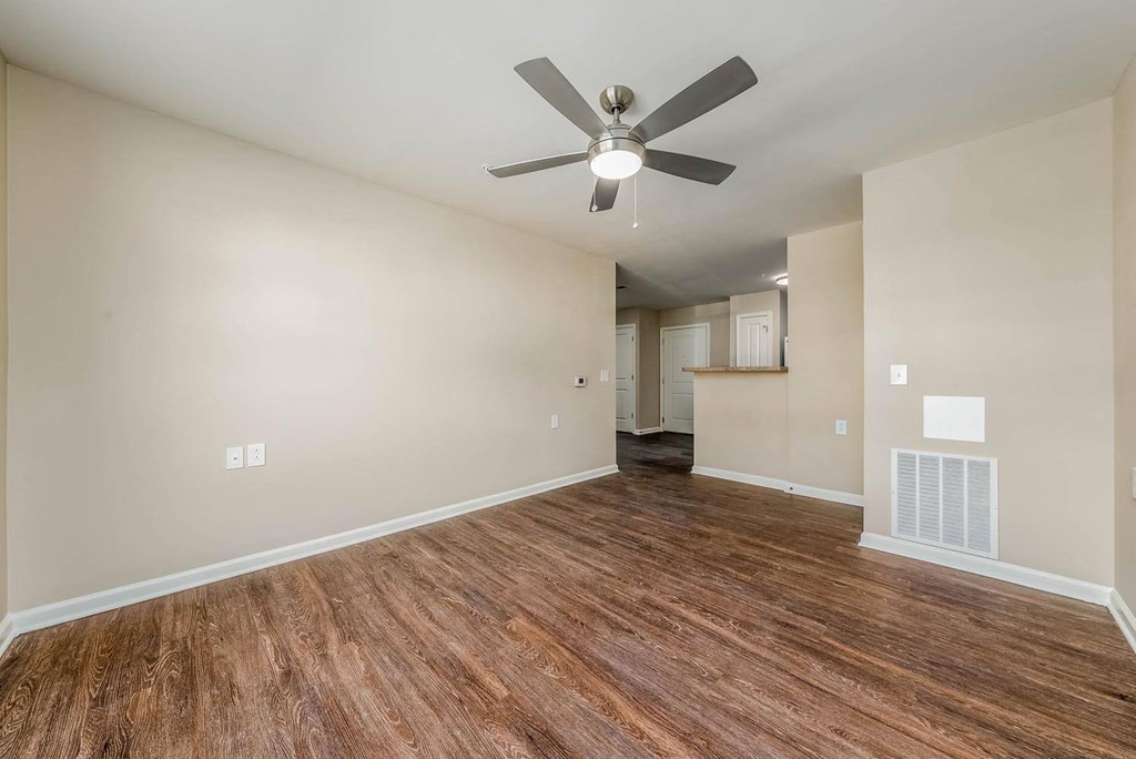 a living room with hardwood floors and a ceiling fan