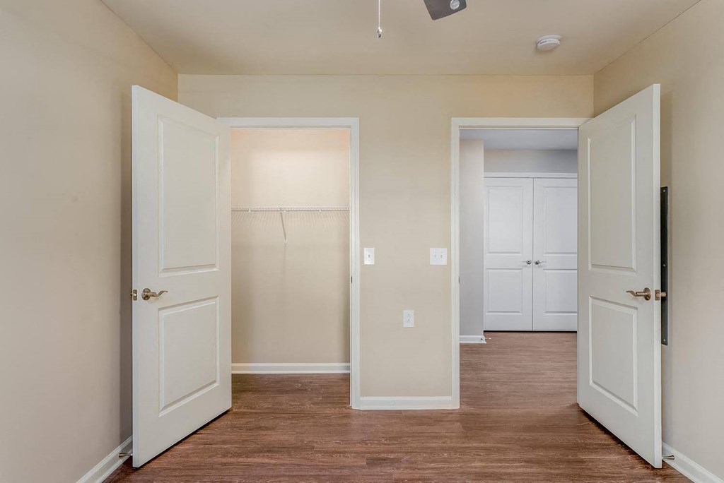 a bedroom with two doors and a closet
