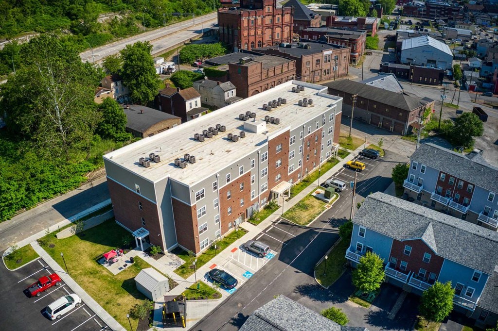 an aerial view of a large brick building with a flat roof